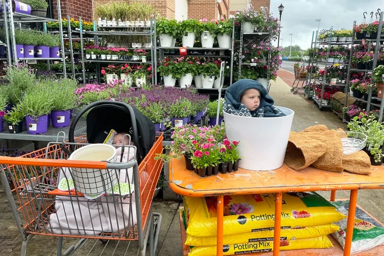 May 13, 2024: Sloan, 2, and Sylvie, 3 months, wait while their parents shop for spring flowers and gardening supplies.