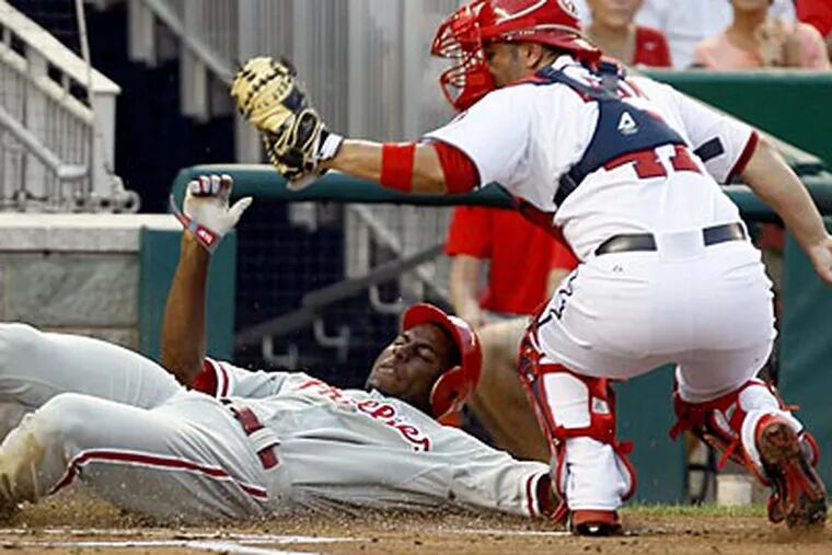 John Mayberry Jr. gets thrown out at home by Bryce Harper in the second inning on Thursday. (Carolyn Kaster/AP)