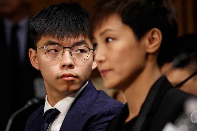 Hong Kong activists Joshua Wong, left, and Denise Ho, attend a Congressional Executive Commission on China (CECC) hearing to examine developments in Hong Kong, Tuesday, Sept. 17, 2019, on Capitol Hill in Washington.