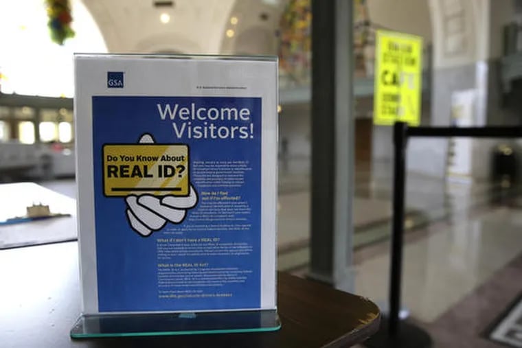 In this April 6, 2016, file photo, a sign at the federal courthouse in Tacoma, Wash., is shown to inform visitors of the federal REAL ID act, which requires state driver's licenses and ID cards to have security enhancements and be issued to people who can prove they are legally in the United States.