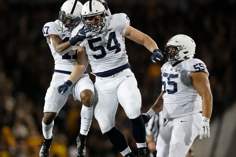 Penn State defensive tackle Robert Windsor (center) celebrates a sack with safety Garrett Taylor (left) and defensive tackle Antonio Shelton against Iowa on Oct. 12, 2019.