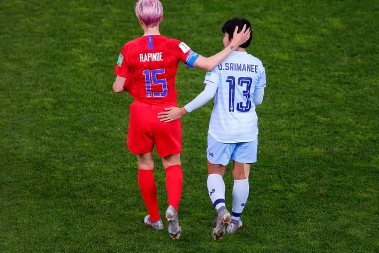 Thailand's Orathai Srimanee and the United States' Megan Rapinoe walked together on the field after the Americans' historic 13-0 rout in the Women's World Cup.