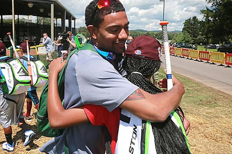 Julian McWilliams hugs Taney's Mo'ne Davis. (David Swanson/Staff Photographer)
