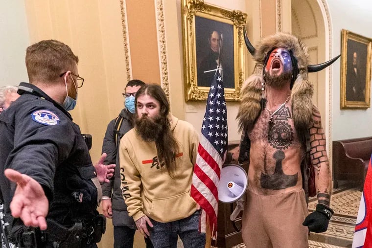 In this Jan. 6 photo is Jacob Chansley, right with fur hat, during the Capitol riot in Washington.