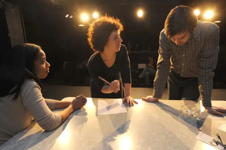 At the Adrienne Theater in Philadelphia, the Flashpoint Theatre Company rehearses the World Premiere of Jacqueline Pardue Goldfinger's Slip/Shot on April 3, 2012.  Here, director Rebecca Wright (center) works with actors Taysha Canales (left) and Kevin Meehan.   APRIL SAUL / Staff Photographer