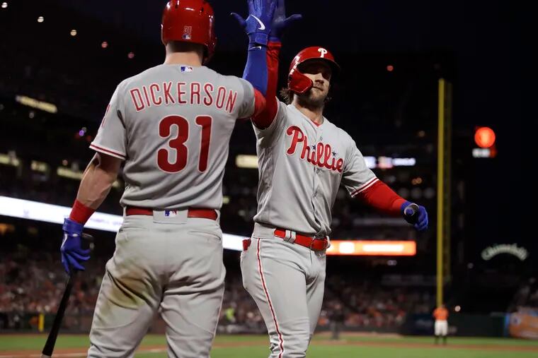 Bryce Harper, right, celebrates after hitting a solo home run in the fifth inning of the Phillies' 9-6 victory over the Giants on Friday night in San Francisco.