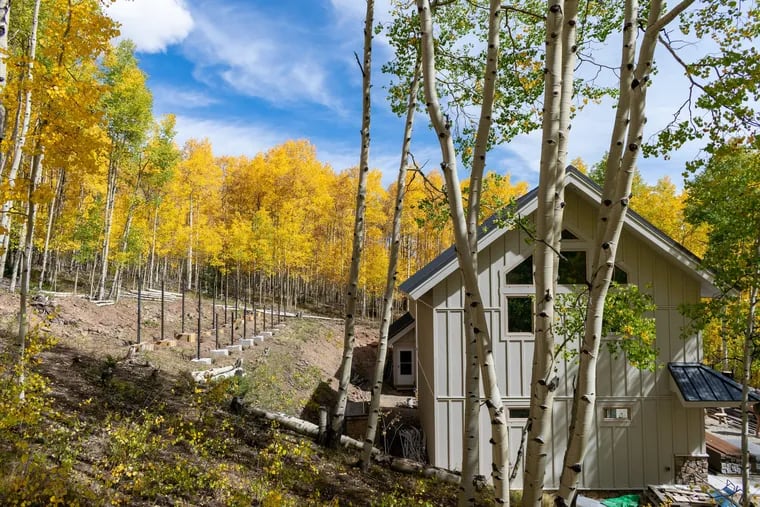VISION House at Mariposa Meadows near Telluride, Colo., is an off-the-grid, resilient and carbon-neutral demonstration home. The structure for the 12kw solar system is nestled into the surrounding aspen forest behind the garage/studio building. (Samantha Carlin/Green Builder Media)