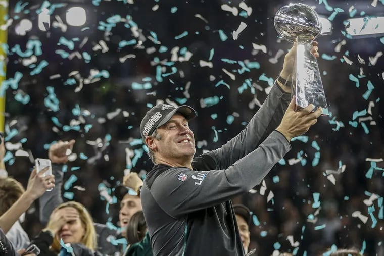 Eagle head coach Doug Pederson hoists the Vince Lombardi Torphy over his head in celebration of the Eagles defeating the New England Patriots in Super Bowl LII, in Minneapolis MN on Febuary, 2018. MICHAEL BRYANT/ Staff Photographer