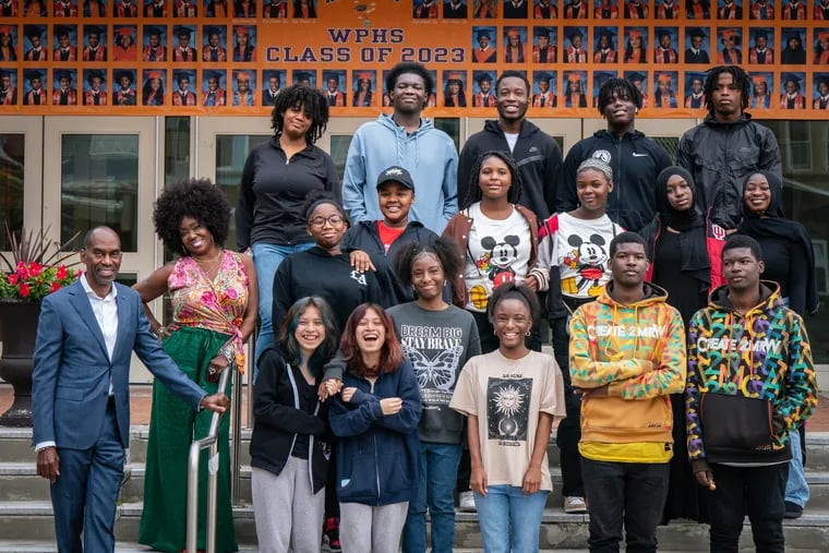 West Philadelphia High has 11 sets of twins among its students this year - and Principal Marla Travis (in flowered shirt) is herself a twin. Some of the West twins are - starting with the top row, left Michelle DeStouet, Jason Lighty, Isaac Deon, Jabril Harper-Haines, and Sa’iyd Harper-Haines, ( Middle row left to right), Mark Travis, far left, and Marla Travis, second from left, Mabel Goodman, Joan Goodman, Shiyanae Hamilton, Mynanah Hamilton, Aminata Sy, Malaou Sy, (Front row left to right) Estrella Enriquez, and Caren Enriquez, Samirah Campbell, Sameah Campbell, Nysear Williams, and Nyeem Williams, at West Philadelphia High School.