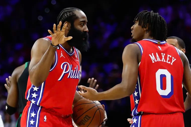 Sixers guard James Harden talks to teammate Tyrese Maxey during Game 3 against the Boston Celtics.