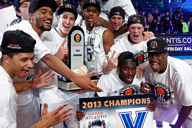 The Villanova basketball team poses with the trophy after winning the Battle 4 Atlantis title with an 88-83 win over Iowa in overtime during an NCAA college basketball game in Paradise Island, Bahamas, Saturday, Nov. 30, 2013. (AP Photo/Bahamas Visual Services, Tim Aylen)