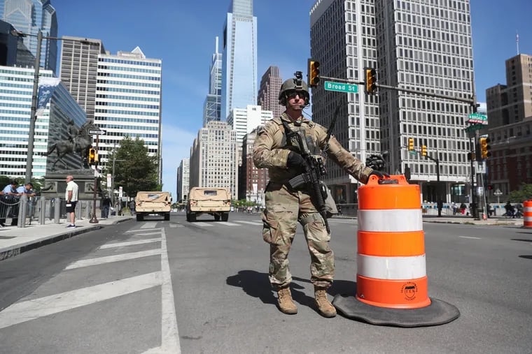 A member of the Pennsylvania National Guard stands at City Hall, at the corner of Broad Street and JFK Boulevard in Philadelphia on Monday.