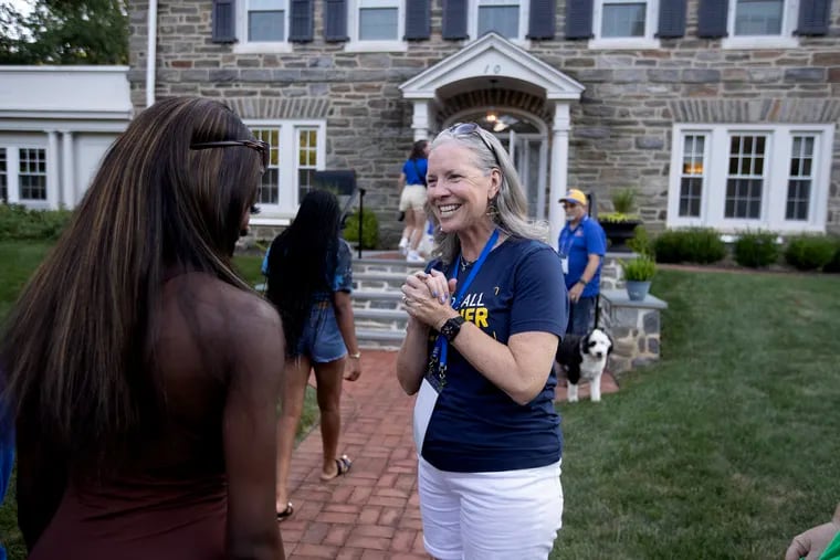 As part of a more intensive outreach to students, Widener University's president Stacey M. Robertson and her husband, Steve, (right) have invited every first-year student - nearly 900 - for dinner at their home over eight nights during the first weeks of classes. Here, she greets the arrival of the students for dinner on Wed., Sept. 6.