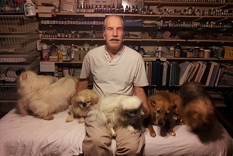 Peter Gerold, a licensed massage therapist, was pictured here with his dogs for a 2014 article published in the Chestnut Hill Local.