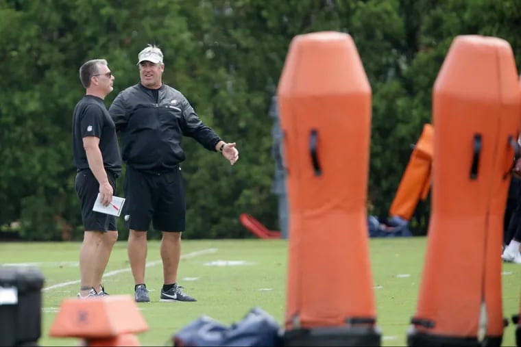 Eaglesâ€™ defensive coordinator Jim Schwartz, left, and head coach Doug Pederson, right, talks as the Eagles hold OTA's at the NovaCare Complex in Philadelphia, PA on May 29, 2018.