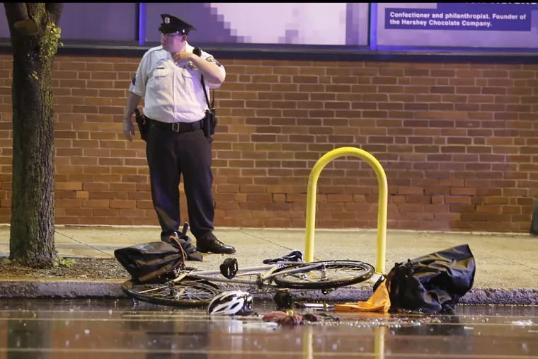 Philadelphia Police investiigate the scene at 10th and Spring Garden St in Phila., Pa. where a SUV vs bicylist accident occured during the evening hours of May 12, 2018.