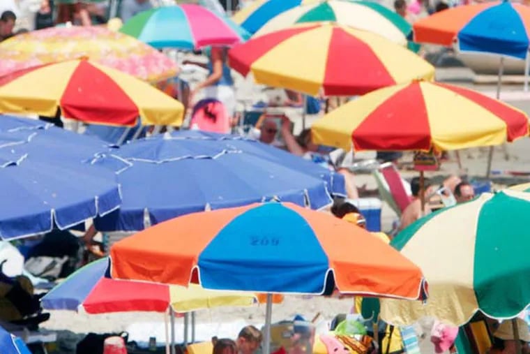 Colorful umbrellas will shield beach goers from the intense sun in Ocean City, NJ all summer long. (Eric Mencher/Inquirer)