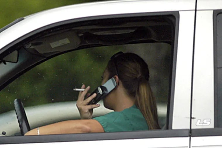 Unidentified driver talks on cell phone at traffic light on the Collingswood / Westmont border. (Tom Gralish / Inquirer)