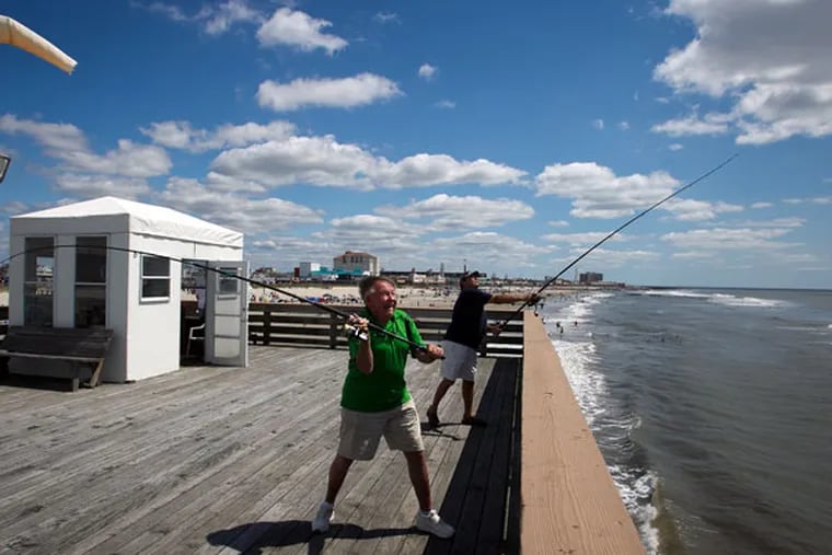 Bob Roth and Frank Pizzutilla cast their lines on Monday from the Ocean City Pier. Both are members of the Ocean City Fishing Club. (ALEJANDRO A. ALVAREZ/STAFF PHOTOGRAPHER)