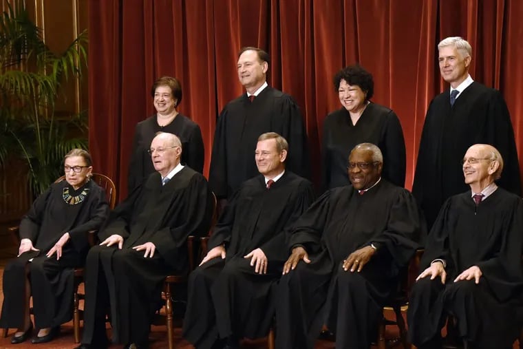 Members of the U.S. Supreme Court pose for a group photograph at the Supreme Court building on June 1.