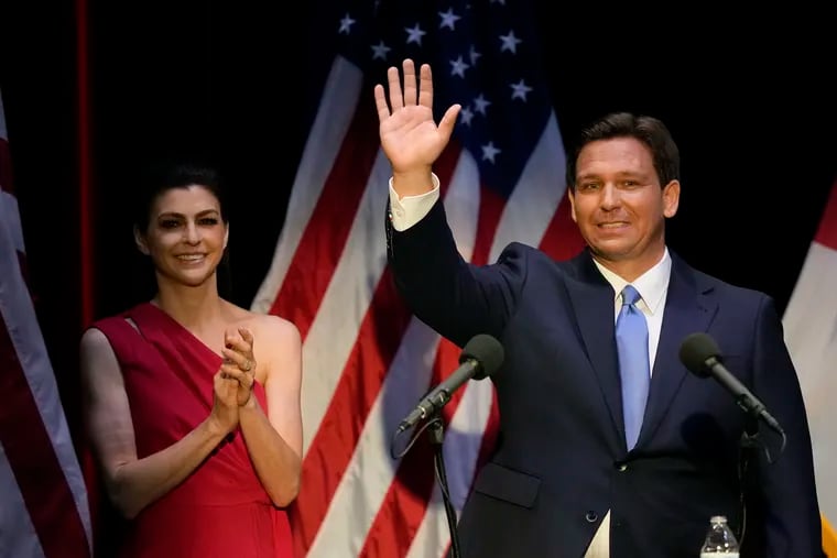 Florida's Republican Gov. Ron DeSantis waves as his wife Casey applauds, following a televised debate against Democratic opponent Charlie Crist, in Fort Pierce, Fla., in October.