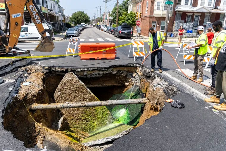 Workers from the Philadelphia Water Department examine the sewage by washing down dyed water to see if there is a hole in the sewage pipe at the cross section of 57th and Media Street  in Philadelphia, Pa., on Wednesday, July 26, 2023.