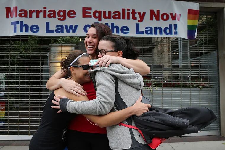 In Chicago , gay-marriage supporters (from left) Christie Jones, Teresa Moreno, and Michelle Gregory celebrate the Supreme Court ruling. ANTONIO PEREZ / Chicago Tribune