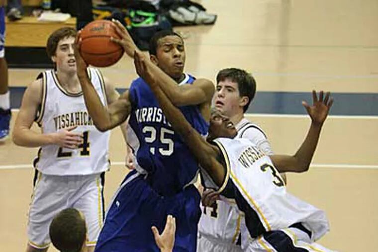 Defended by a diving Bobby Beckett (#3) of Wissahickon, Norristown's Jarrell Gardner goes up for a layup on Friday. ( Kevin Cook / Staff Photographer )