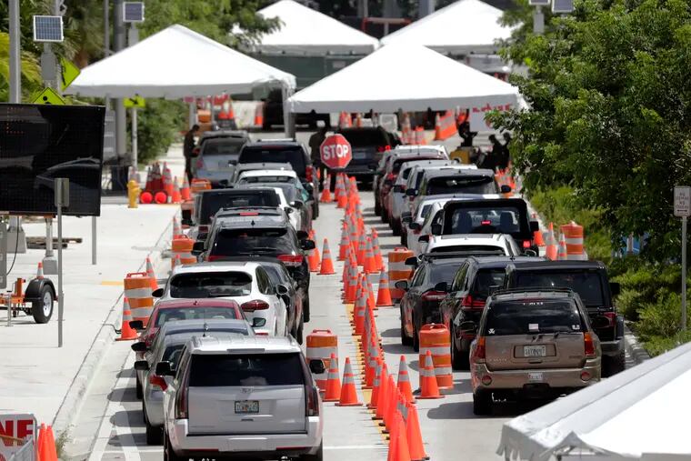 Drive-through swab collection sites -- like this one outside the Miami Beach Convention Center -- are part of what makes the current coronavirus testing approach so unwieldy and inadequate. Convenient, fast, at-home diagnostic tests could be a solution . (AP Photo/Wilfredo Lee, File)