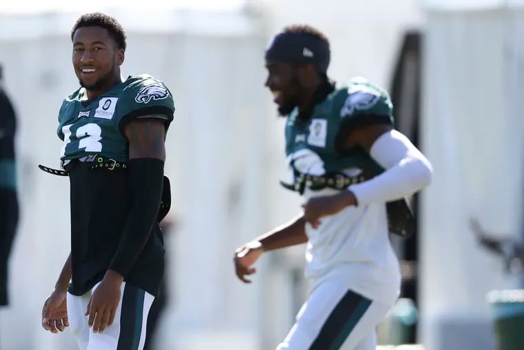 Eagles wide receiver Travis Fulgham (left) smiles during practice on Wednesday.