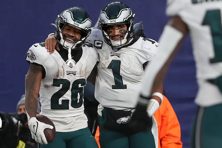Eagles running back Miles Sanders (left) celebrates with quarterback Jalen Hurts after he scored in the fourth quarter against the Giants.
