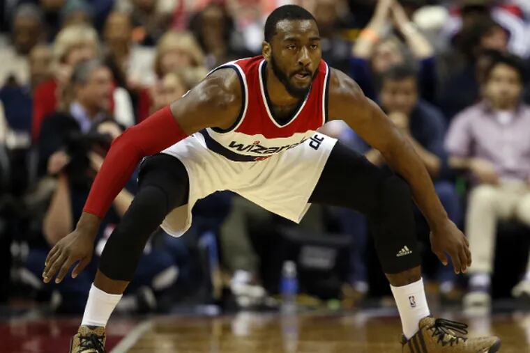 John Wall gets into defensive position during the Wizards' game against the Sixers.