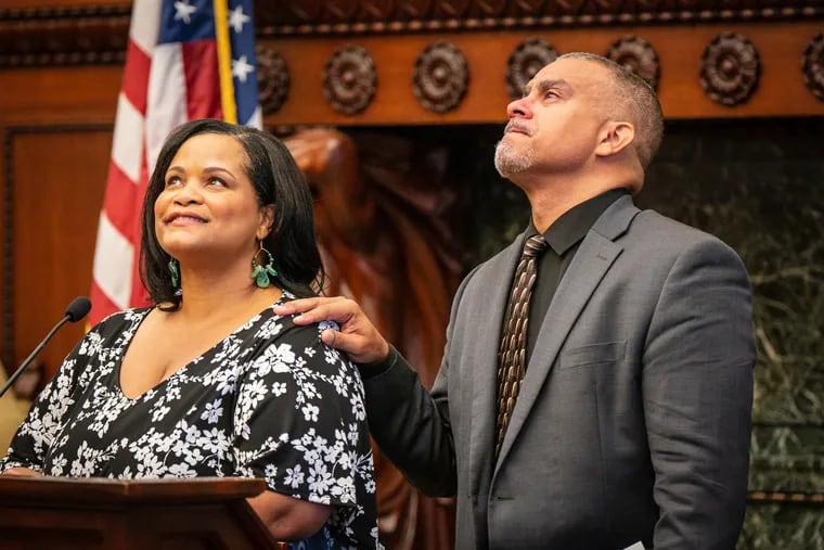 Melissa Urbina, niece, and Ernest Todd Stewart, son, share memories of Joseph Certaine in the Mayor's Reception Room in City Hall. Certaine died in late July.