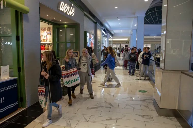 Shoppers outside the Aerie store inside the King of Prussia Mall on Black Friday, November 26, 2021. Staff controlled the flow of shoppers into the store.