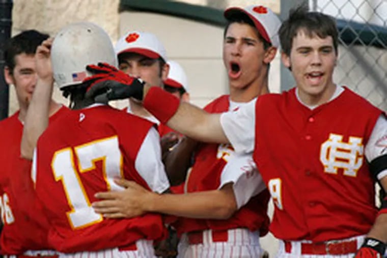 Cherry Hill East&#0039;s Max McGee (17) is congratulated by teammates after scoring his team&#0039;s third run.