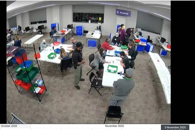 In this screenshot from the Delaware County Bureau of Elections' livefeed, ballot counters (in the foreground) are being watched by bipartisan poll observers from a nearby table. A video circulating social media on Friday cropped out the observers, leading some to push a false theory that the ballots were being manipulated.