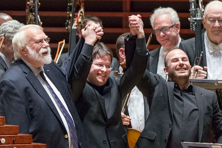Composer Christopher Rouse (left) acknowledges the audience, with soloist Paul Jacobs (center) and Yannick N&#0233;zet-S&#0233;guin.