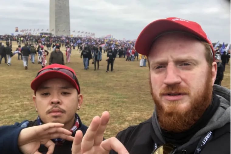 Proud Boy Brian Healion (right) poses for a selfie with Freedom Vy (left) a fellow member of the far-right group's Philadelphia chapter, near the Washington Monument in Washington, D.C. on Jan. 6, 2021.