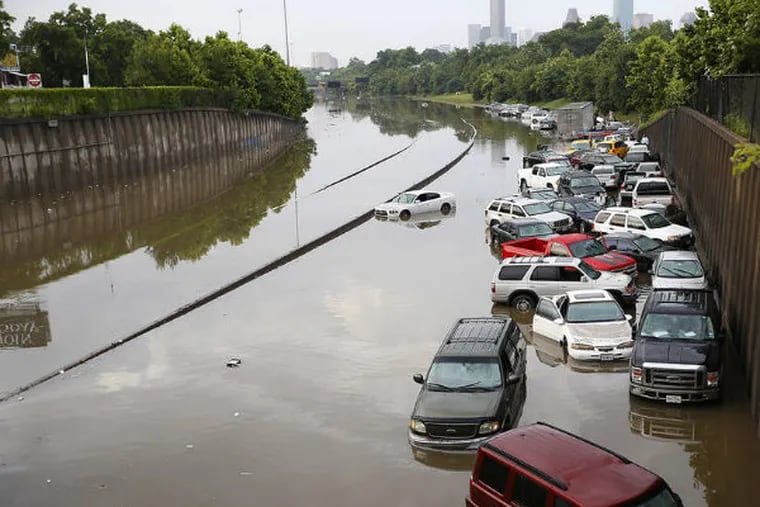 Vehicles are stalled in high water on I-45 north of downtown Houston, where another foot of rain fell Tuesday. (Cody Duty/Houston Chronicle)