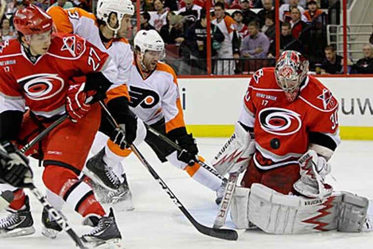 Hurricanes goalie Cam Ward makes a stop against the Flyers in the first period. (Gerry Broome/AP Photo)