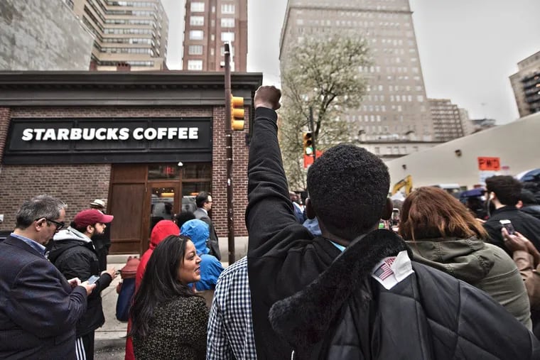 Christopher Potts, center, protest outside the Starbucks on 18th and Spruce Streets.