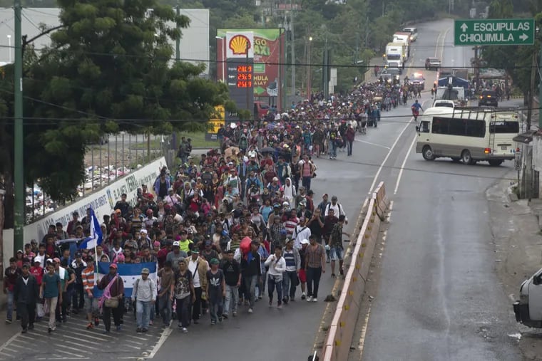 Honduran migrants walking toward the U.S.  depart Chiquimula, Guatemala, last Wednesday. The group of some 2,000 Honduran migrants hopes to reach the United States despite President Trump's threat to cut off aid to Central American countries that don't stop them.
