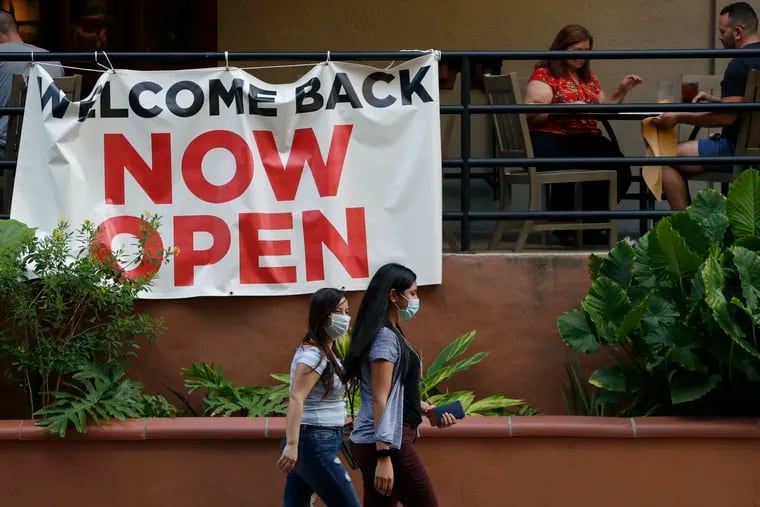 Visitors to the River Walk pass a restaurant that has reopened in San Antonio in May. Coronavirus cases are rising in nearly half the U.S. states, as states are rolling back lockdowns. (AP Photo/Eric Gay, File)