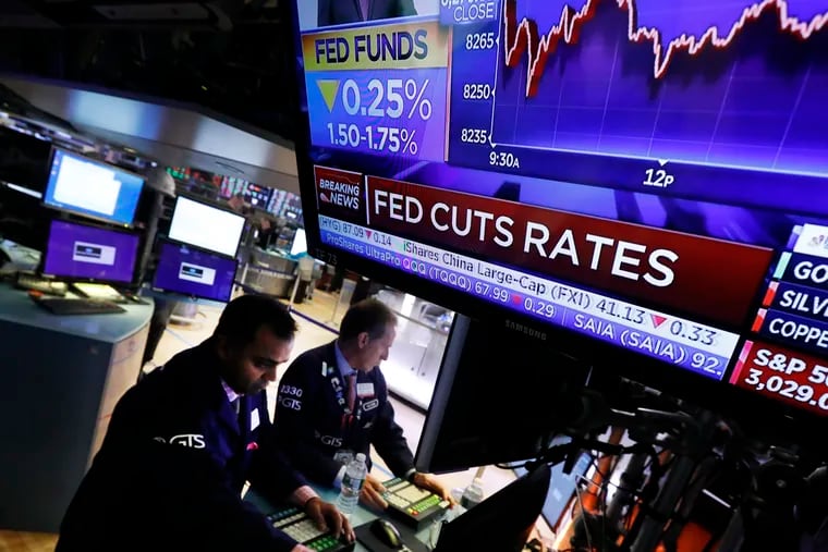 A television screen on the floor of the New York Stock Exchange shows the rate decision of the Federal Reserve, Wednesday, Oct. 30, 2019. The Federal Reserve has cut its benchmark interest rate for the third time this year to try to sustain the economic expansion in the face of global threats.
