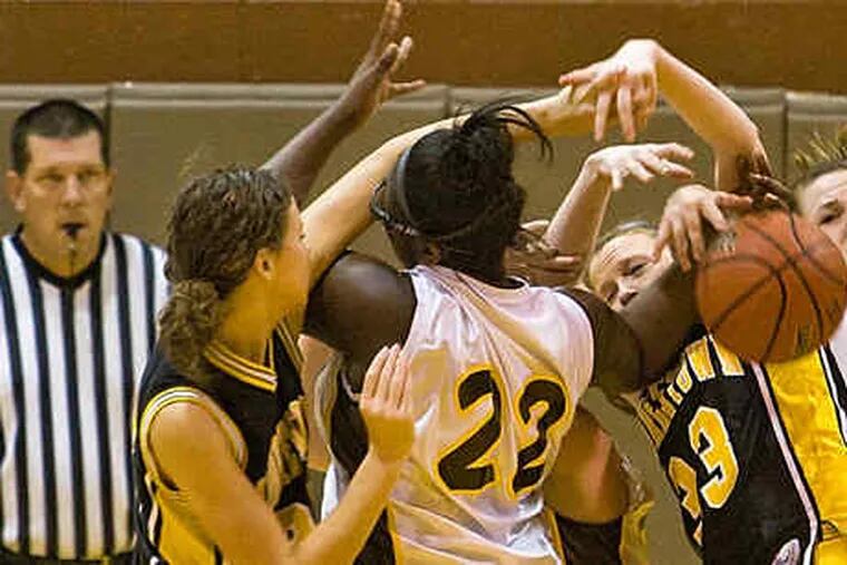 A mass of players, Moorestown's Nikki McMonagle (left) and Lauren Leskow (33), and Delran's Crystal Cleveland (22) and Jess McHugh (15), fight for possession of a rebound.