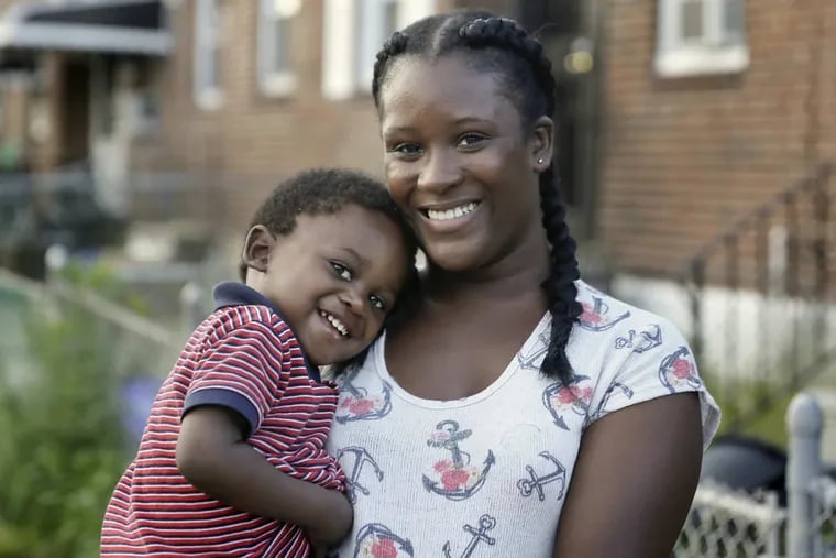 Stephanie Sakho and her son, Momo, 1, near their Southwest Philadelphia home.