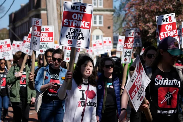 Strikers march in front of Rutgers' buildings in New Brunswick, N.J., on April 10, 2023. Faculty and graduate student workers went on strike for a week and ratified new contract deals in early May. The resident physicians and fellows , who were not part of the strike, have reached a tentative agreement on a new contract.