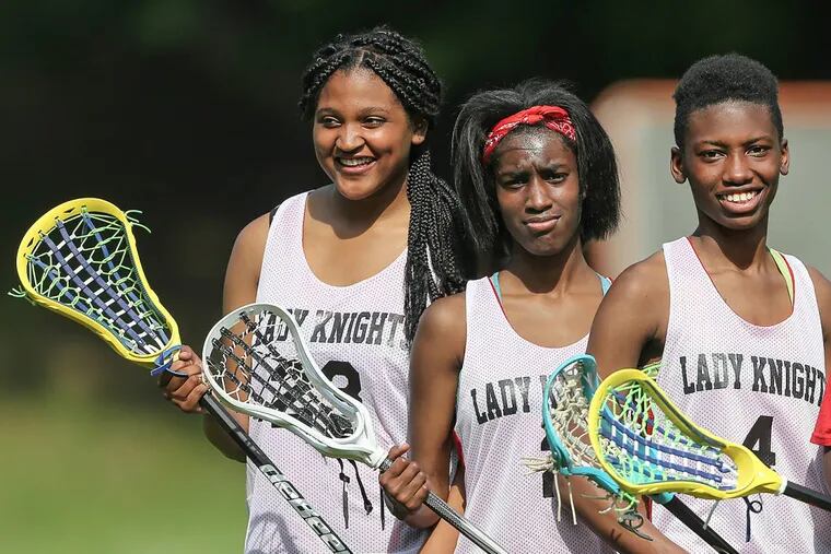 Strawberry Mansion’s lacrosse team —  with players (from left)  Kava Thompson, Nadirah Gateward and Nadirah McRae — is part of a bias class-action suit.