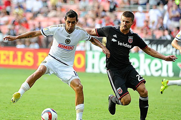 Union midfielder Cristian Maidana posses the ball as D.C. United midfielder/defender Perry Kitchen defends.