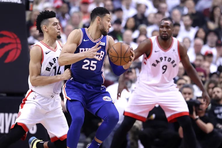 Ben Simmons, center, of the Sixers tries to drive between Danny Green, left, and Serge Ibaka of the Raptors during their NBA Eastern Conference Semifinal Playoff Game at the Wells Fargo Center on May 5, 2019.